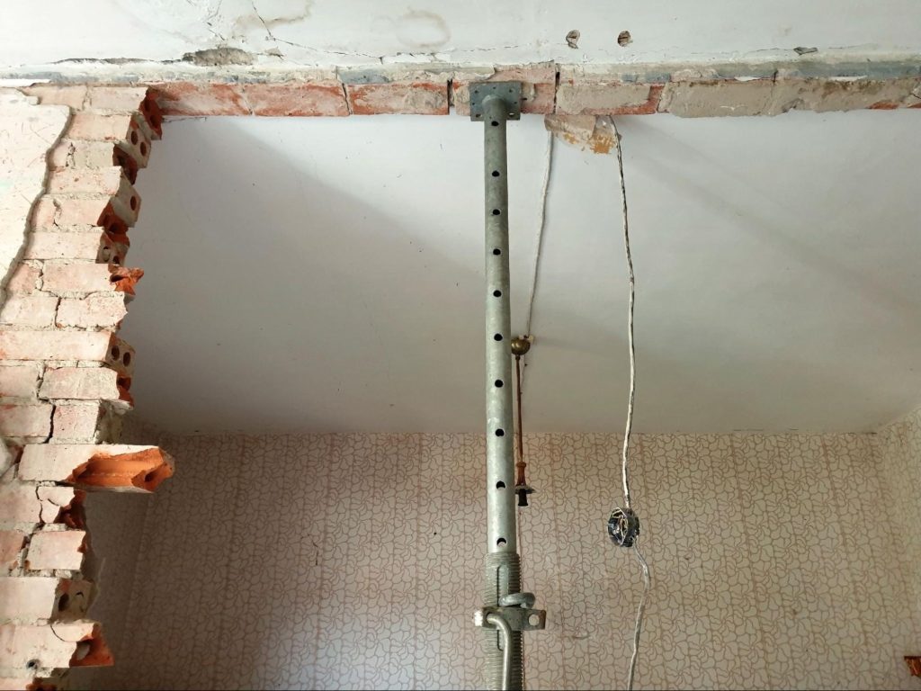 Interior wall opening with temporary structural support during renovation.