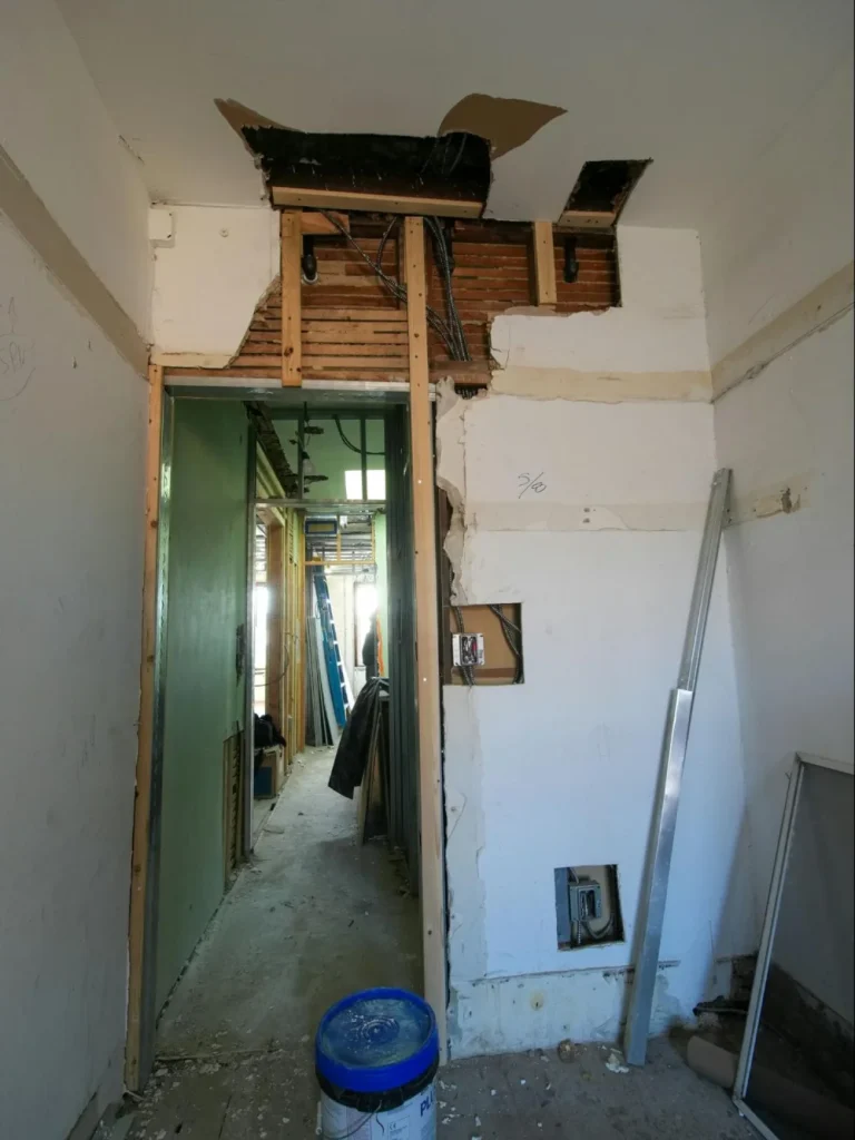 Opened wall and doorway during an open floor plan remodeling project